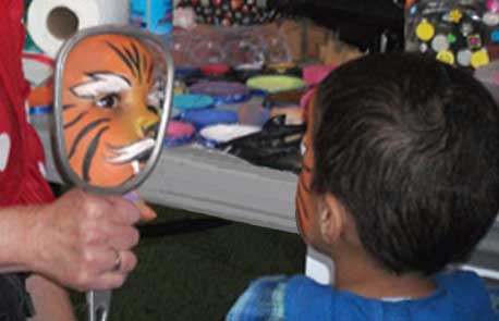 Photo of a boy awed by his tiger face-paint